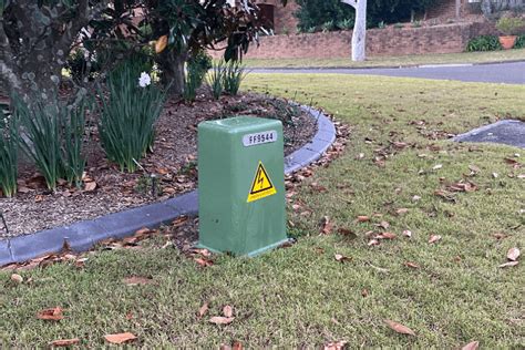 green electricity box outside house